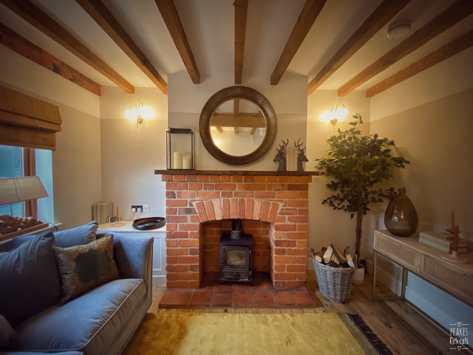 cosy English country cottage living room with woodturner in brick fireplace